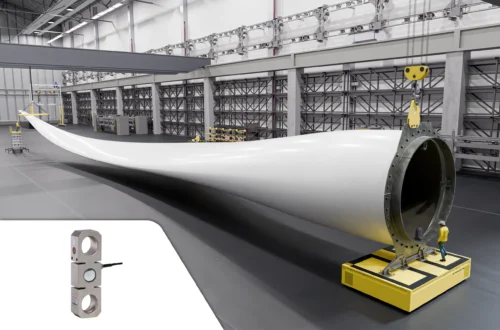 Giant wind turbine blade being weighed using a tension load cell and custom shackle.